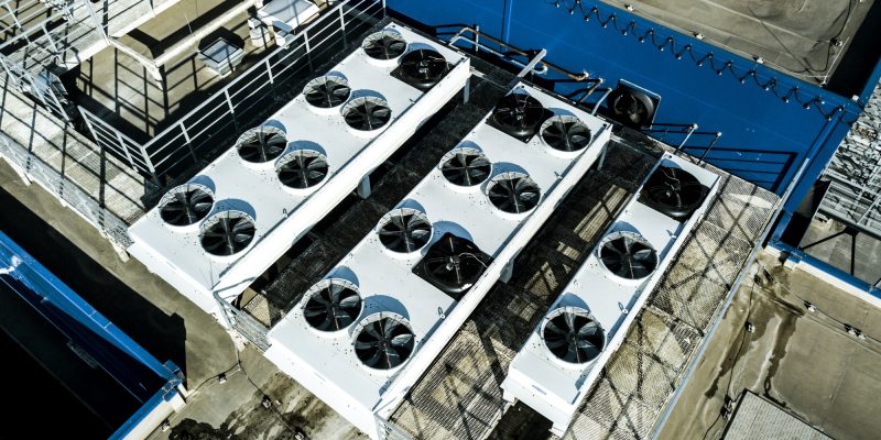 Air compressors on roof top of warehouse