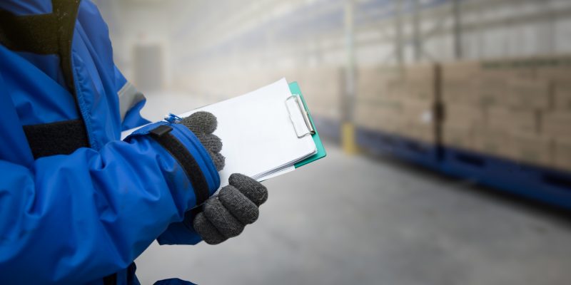 Technician checking warehouse conditions